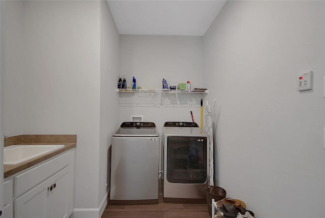 14501 Wabasso Loop, Winter Garden, FL 34787 - laundry area featuring washing machine and clothes dryer, wood finished floors, baseboards, and cabinet space