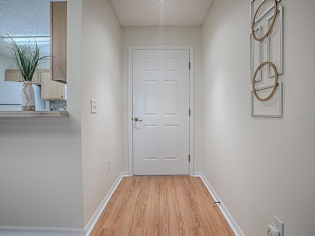 2799 Privada Dr, The Villages, FL 32162 - corridor with light wood-style flooring and baseboards