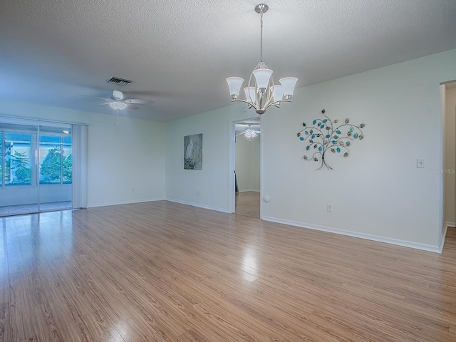 2799 Privada Dr, The Villages, FL 32162 - spare room with a ceiling fan, light wood-style floors, a chandelier, and a textured ceiling