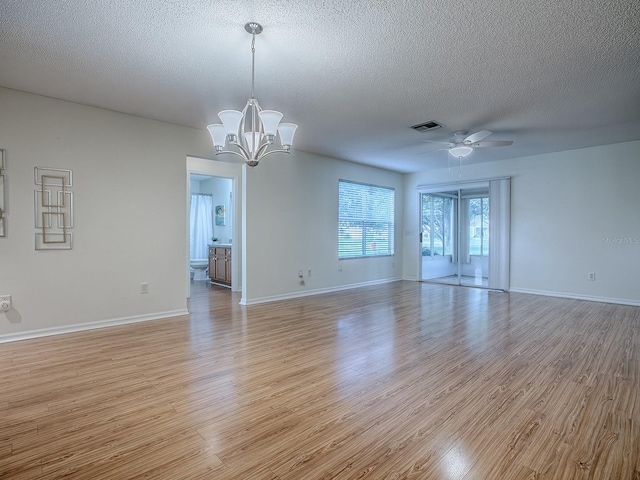 2799 Privada Dr, The Villages, FL 32162 - unfurnished room with light wood-style flooring, ceiling fan, a textured ceiling, and a chandelier