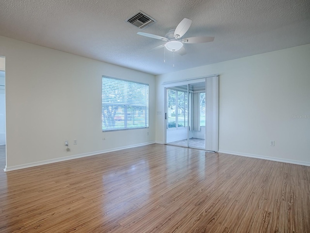 2799 Privada Dr, The Villages, FL 32162 - unfurnished room featuring a ceiling fan, light wood finished floors, and a textured ceiling