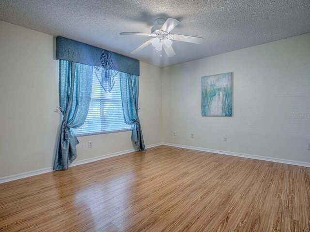 2799 Privada Dr, The Villages, FL 32162 - empty room with wood finished floors, a ceiling fan, and a textured ceiling