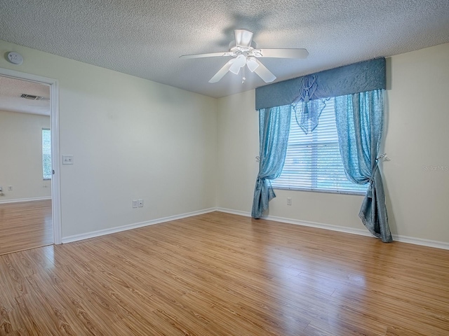 2799 Privada Dr, The Villages, FL 32162 - spare room with a smoke detector, wood finished floors, a textured ceiling, and ceiling fan