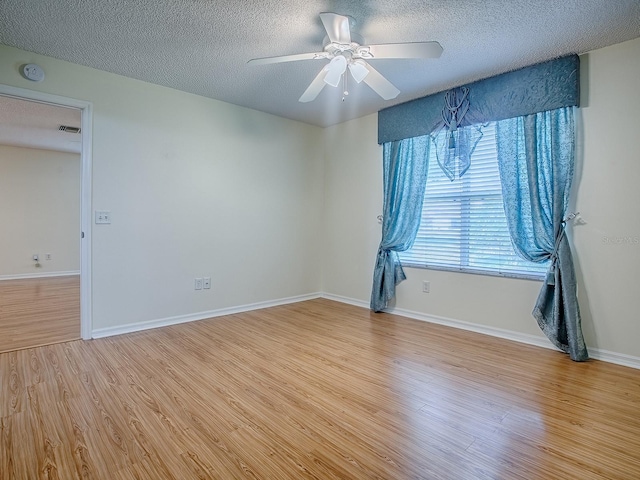 2799 Privada Dr, The Villages, FL 32162 - spare room with wood finished floors, a textured ceiling, a ceiling fan, and a smoke detector