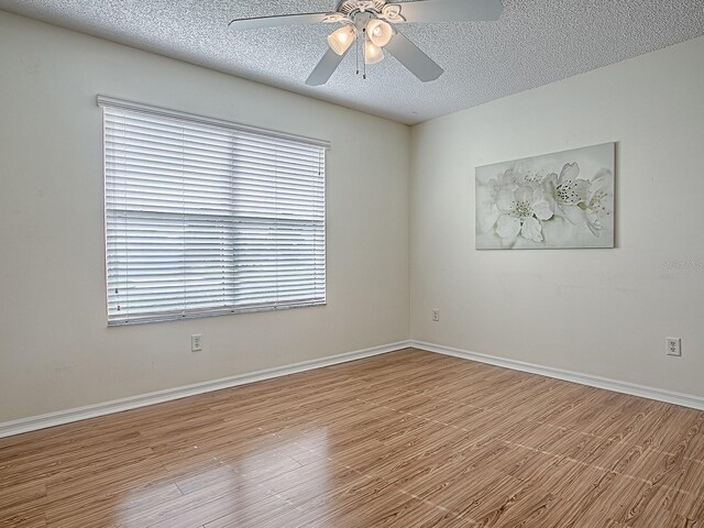 2799 Privada Dr, The Villages, FL 32162 - spare room with a ceiling fan, wood finished floors, and a textured ceiling