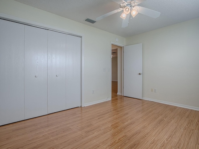 2799 Privada Dr, The Villages, FL 32162 - unfurnished bedroom with light wood-type flooring, a closet, and ceiling fan