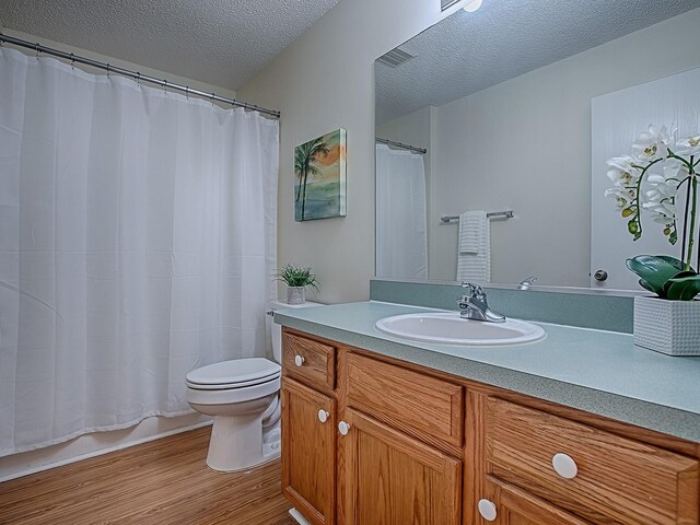 2799 Privada Dr, The Villages, FL 32162 - full bathroom featuring wood finished floors, a textured ceiling, and vanity