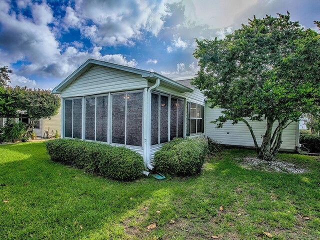 2799 Privada Dr, The Villages, FL 32162 - view of home's exterior with a yard and a sunroom