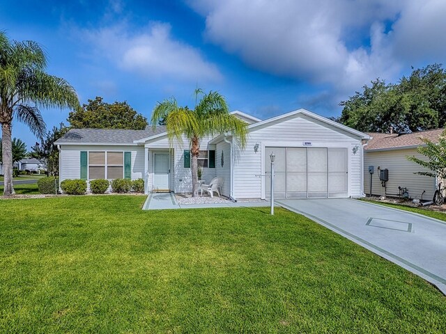 2799 Privada Dr, The Villages, FL 32162 - ranch-style house with an attached garage, concrete driveway, and a front lawn