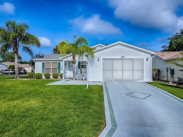 2799 Privada Dr, The Villages, FL 32162 - ranch-style house with driveway, a garage, and a front yard