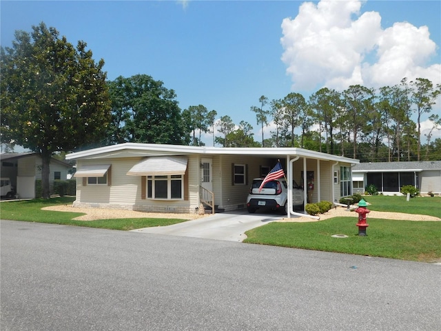 146 Hibiscus Way, Leesburg, FL 34748 - view of front of house featuring a front yard, an attached carport, and driveway