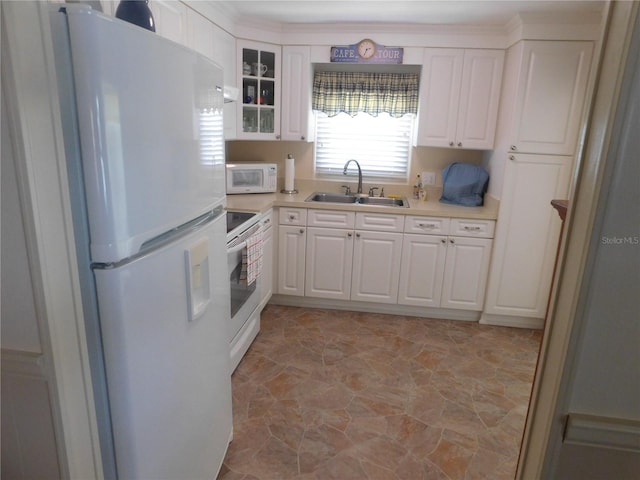 146 Hibiscus Way, Leesburg, FL 34748 - kitchen with white appliances, a sink, white cabinets, and light countertops