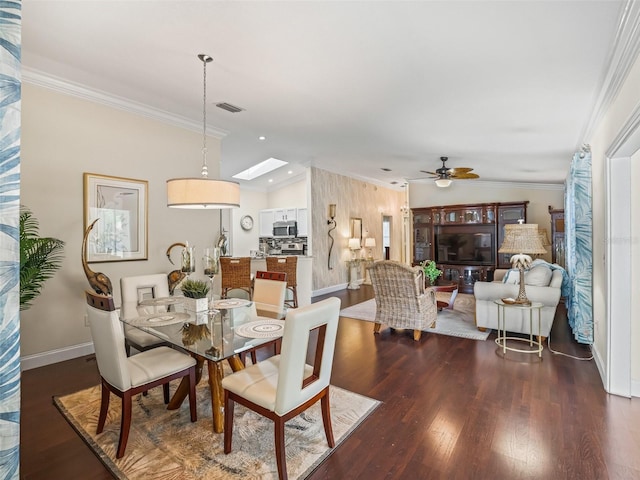 17324 SE 82nd Pecan Ter, The Villages, FL 32162 - dining space featuring crown molding, wood finished floors, ceiling fan, baseboards, and a skylight