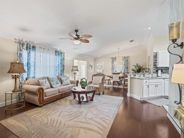 17324 SE 82nd Pecan Ter, The Villages, FL 32162 - living area featuring crown molding, a ceiling fan, dark wood-type flooring, baseboards, and recessed lighting