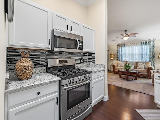 17324 SE 82nd Pecan Ter, The Villages, FL 32162 - kitchen with appliances with stainless steel finishes, ornamental molding, backsplash, open floor plan, and dark wood-type flooring