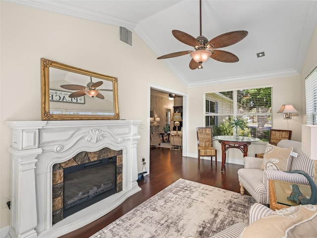 17324 SE 82nd Pecan Ter, The Villages, FL 32162 - living room featuring ceiling fan, lofted ceiling, wood finished floors, a glass covered fireplace, and crown molding