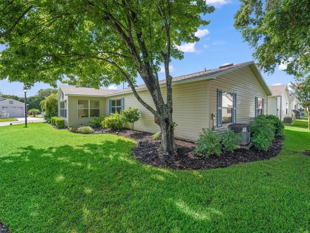 17324 SE 82nd Pecan Ter, The Villages, FL 32162 - view of home's exterior featuring a lawn and central AC unit