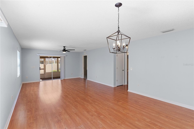 1116 San Bernardo Rd, The Villages, FL 32162 - unfurnished room with a chandelier, a ceiling fan, light wood-style flooring, and baseboards