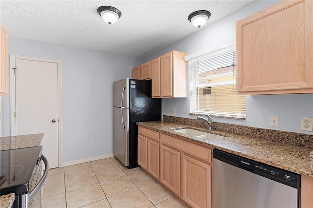 1116 San Bernardo Rd, The Villages, FL 32162 - kitchen featuring appliances with stainless steel finishes, a sink, light brown cabinetry, a textured ceiling, and stone counters