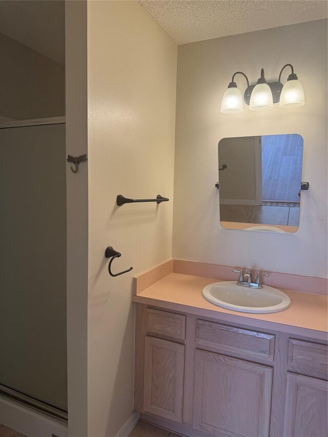 1116 San Bernardo Rd, The Villages, FL 32162 - bathroom featuring vanity, a textured ceiling, and a stall shower