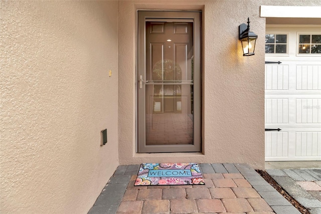 15531 Waterleigh Cove Dr, Winter Garden, FL 34787 - doorway to property with stucco siding