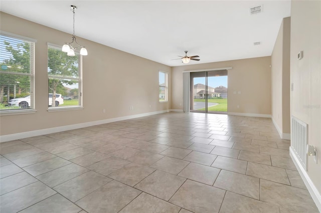15531 Waterleigh Cove Dr, Winter Garden, FL 34787 - empty room featuring ceiling fan, light tile patterned floors, and a chandelier