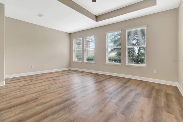 15531 Waterleigh Cove Dr, Winter Garden, FL 34787 - empty room with light wood-type flooring, a raised ceiling, and ceiling fan
