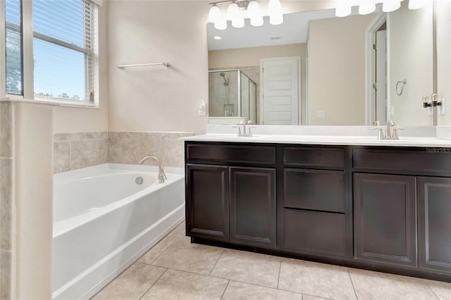 15531 Waterleigh Cove Dr, Winter Garden, FL 34787 - bathroom featuring double vanity, tile patterned floors, a stall shower, and a garden tub