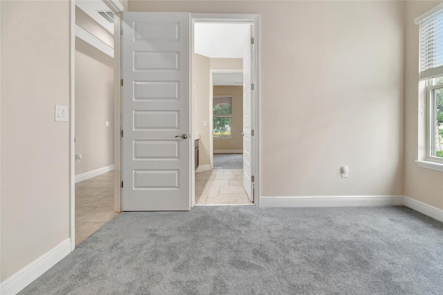 15531 Waterleigh Cove Dr, Winter Garden, FL 34787 - unfurnished bedroom featuring carpet flooring, multiple windows, and tile patterned flooring