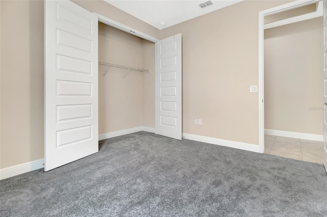 15531 Waterleigh Cove Dr, Winter Garden, FL 34787 - unfurnished bedroom with carpet flooring, a closet, and tile patterned floors