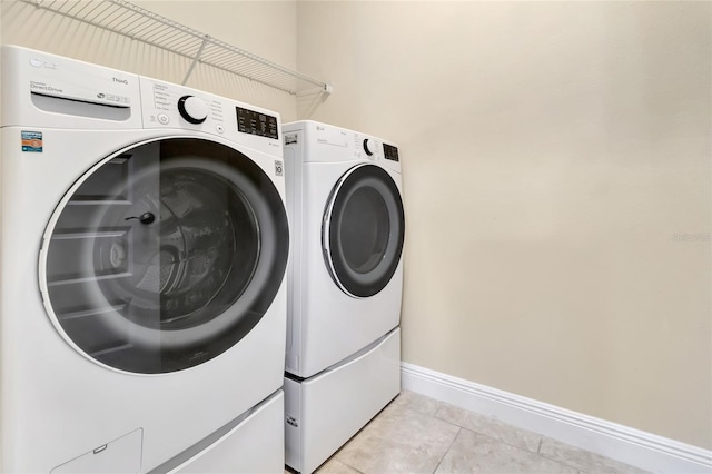 15531 Waterleigh Cove Dr, Winter Garden, FL 34787 - laundry room featuring separate washer and dryer and light tile patterned floors
