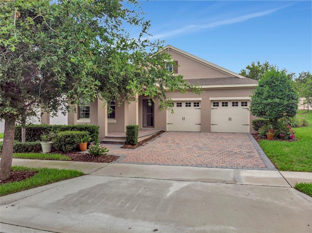 15531 Waterleigh Cove Dr, Winter Garden, FL 34787 - view of front of property featuring stucco siding, decorative driveway, and an attached garage