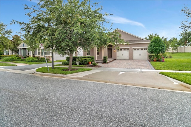 15531 Waterleigh Cove Dr, Winter Garden, FL 34787 - view of property hidden behind natural elements with driveway, a garage, and a front lawn