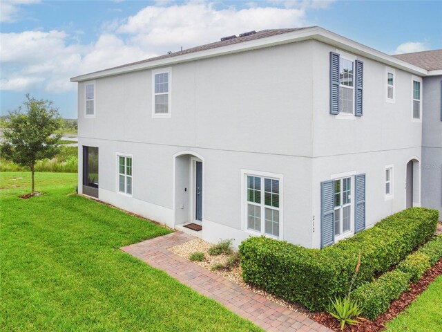212 Primrose Dr, Davenport, FL 33837 - back of property featuring a yard and stucco siding