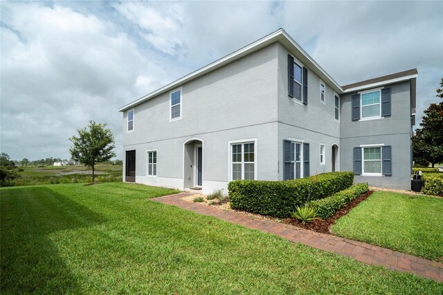 212 Primrose Dr, Davenport, FL 33837 - rear view of property with a yard and stucco siding