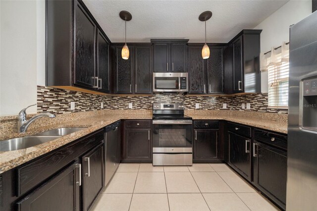 212 Primrose Dr, Davenport, FL 33837 - kitchen featuring stainless steel appliances, a sink, light tile patterned flooring, and decorative backsplash
