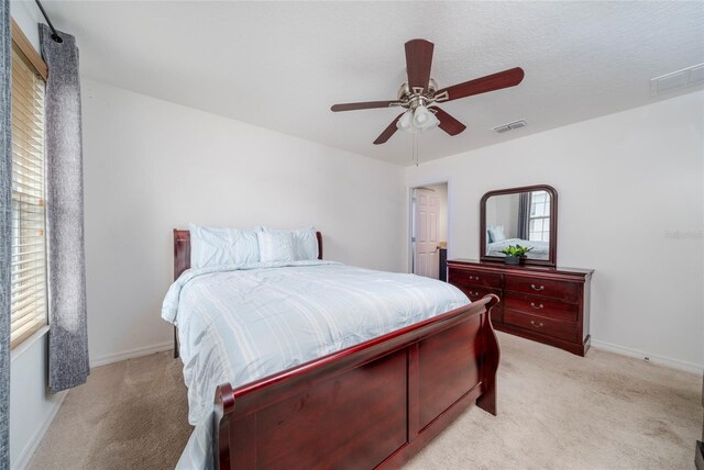 212 Primrose Dr, Davenport, FL 33837 - bedroom with light carpet, baseboards, and a ceiling fan