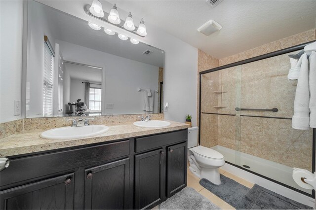 212 Primrose Dr, Davenport, FL 33837 - bathroom with double vanity, a shower stall, toilet, and tile patterned flooring