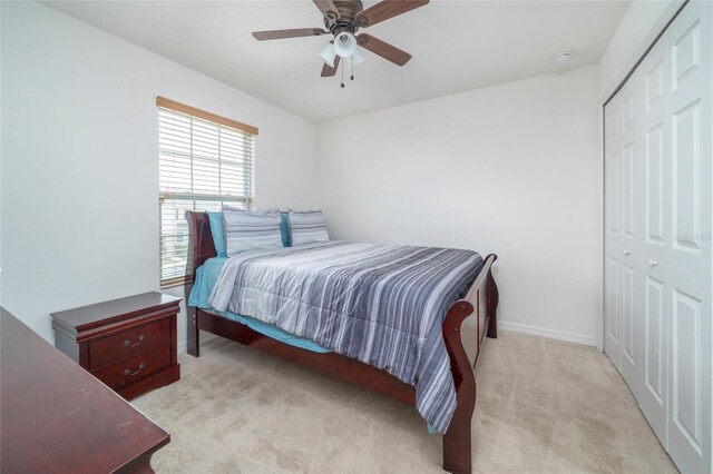 212 Primrose Dr, Davenport, FL 33837 - bedroom with light carpet, a closet, a ceiling fan, and baseboards