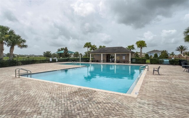 212 Primrose Dr, Davenport, FL 33837 - community pool featuring a patio