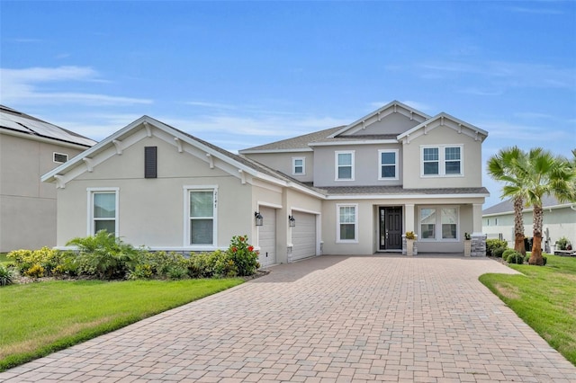 2147 Timber Creek Ln, Clermont, FL 34715 - view of front of house with decorative driveway, stucco siding, an attached garage, and a front yard
