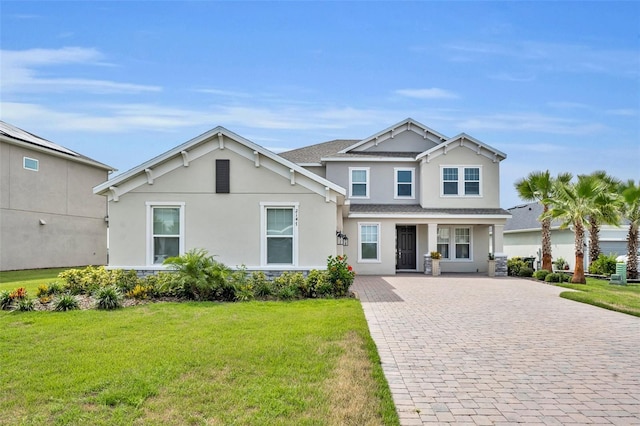 2147 Timber Creek Ln, Clermont, FL 34715 - craftsman-style home featuring stucco siding, decorative driveway, a front yard, and roof with shingles