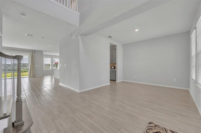 2147 Timber Creek Ln, Clermont, FL 34715 - unfurnished living room featuring baseboards, light wood-style floors, and recessed lighting
