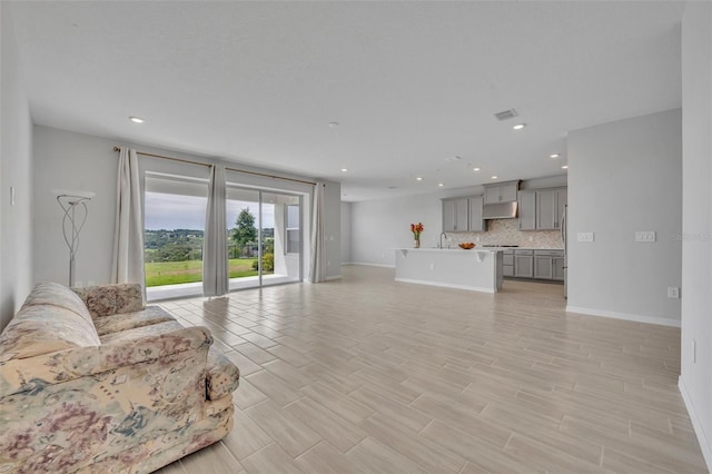 2147 Timber Creek Ln, Clermont, FL 34715 - living room featuring baseboards, recessed lighting, and light wood-style flooring