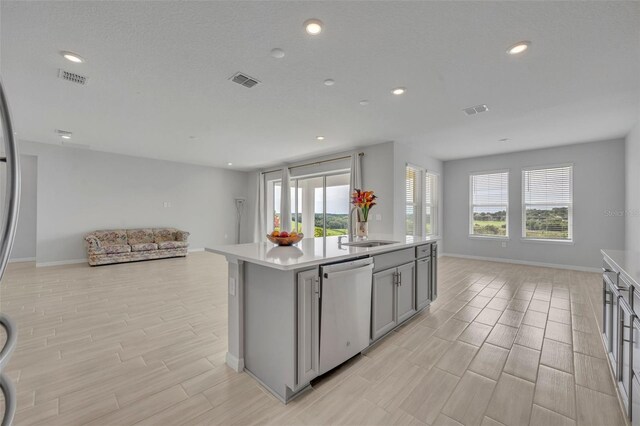 2147 Timber Creek Ln, Clermont, FL 34715 - kitchen with open floor plan, dishwasher, gray cabinets, a sink, and wood tiled floors
