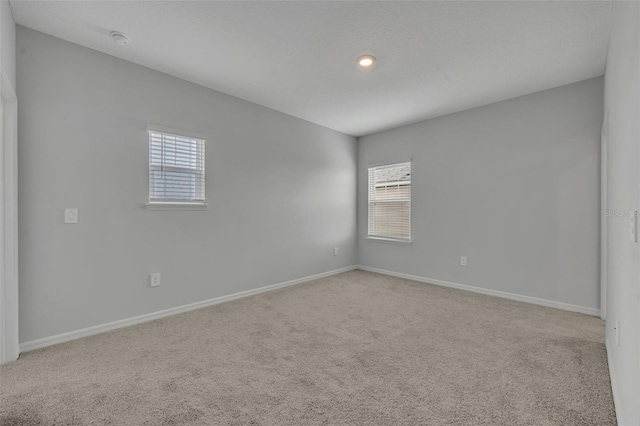 2147 Timber Creek Ln, Clermont, FL 34715 - carpeted empty room featuring healthy amount of natural light, baseboards, and a smoke detector