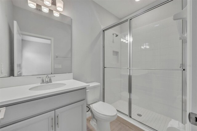 2147 Timber Creek Ln, Clermont, FL 34715 - full bath with toilet, vanity, a stall shower, and wood finished floors