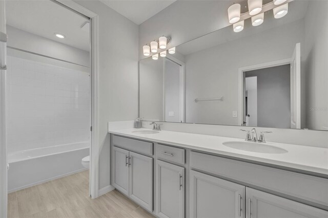 2147 Timber Creek Ln, Clermont, FL 34715 - full bath featuring double vanity, toilet, wood finished floors, and tub / shower combination