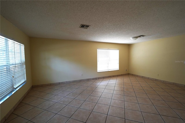 2007 Country Brook Ave, Clermont, FL 34711 - empty room with light tile patterned floors and a textured ceiling