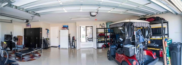 3466 Smedley Rd, The Villages, FL 32163 - garage featuring freestanding refrigerator and a garage door opener
